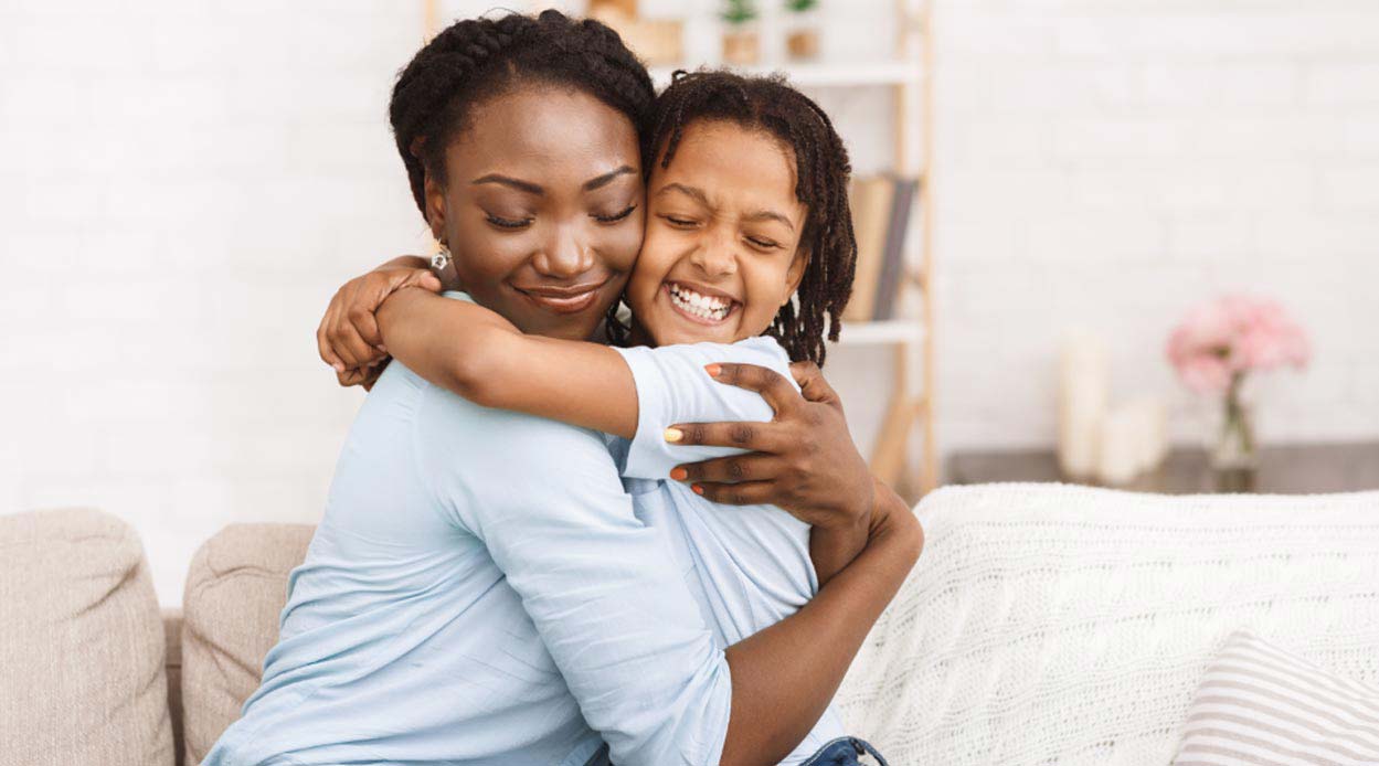 mother and daughter happy and hugging